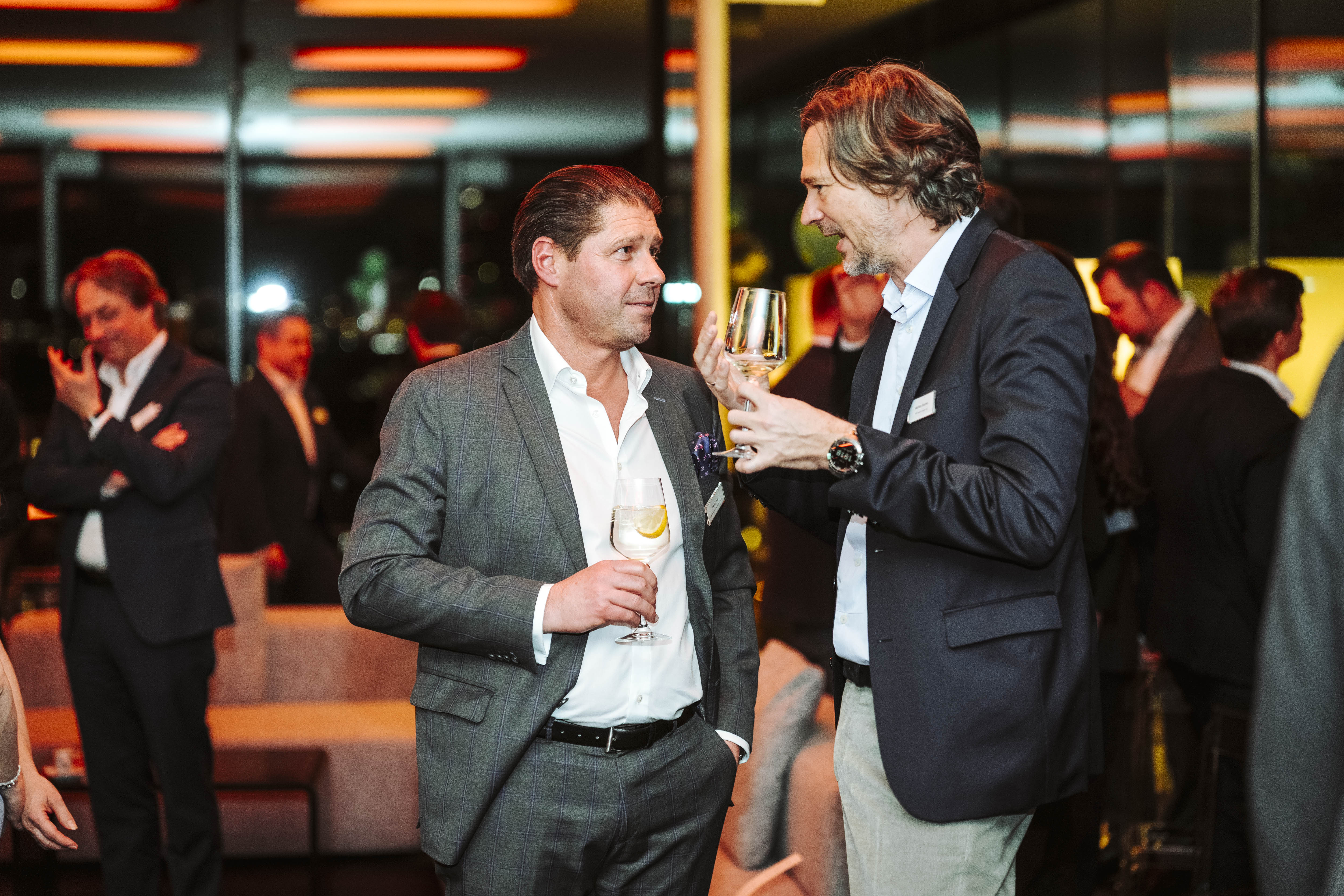 Zwei Geschäftsmänner unterhalten sich auf einer Veranstaltung. Foto von Nadine Studeny.
