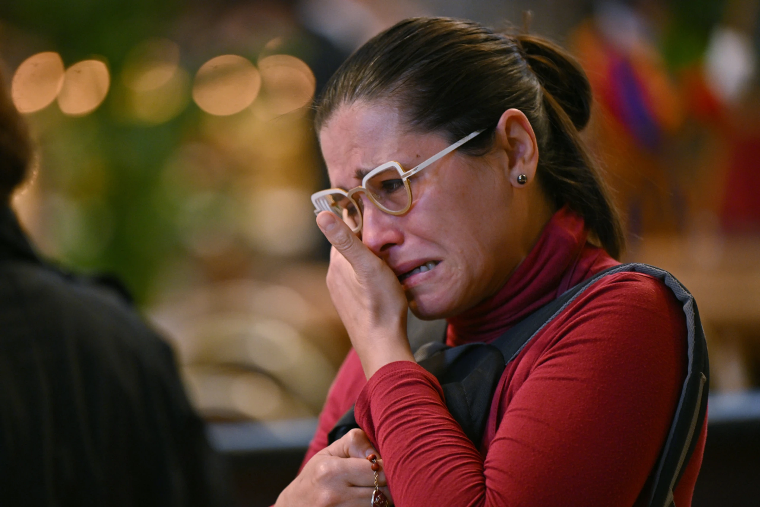 Eine Frau weint beim Gedenken an den verstorbenen Papst Franziskus