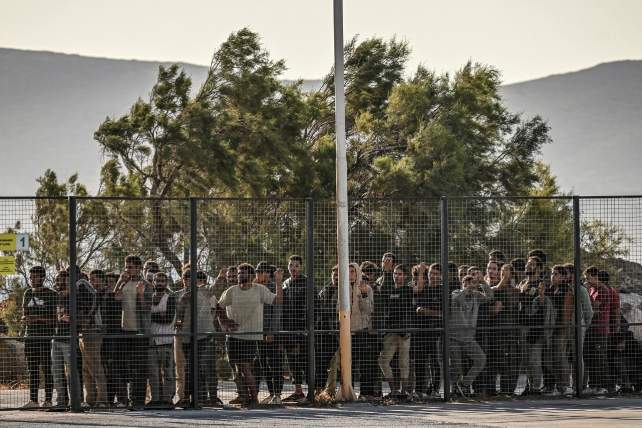 Migranten hinter einen Zaun in Griechenland